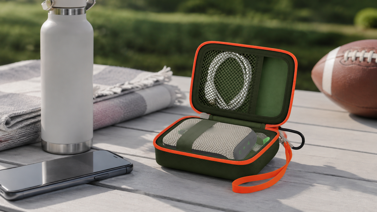 ALKOO green for JBL Go speaker travel case on a gray-white outdoor table for football weekend packing